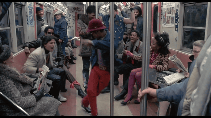 Танець молодого талановитого b-boy у вагоні Нью-Йоркського метрополітену. Публіка в захваті.
